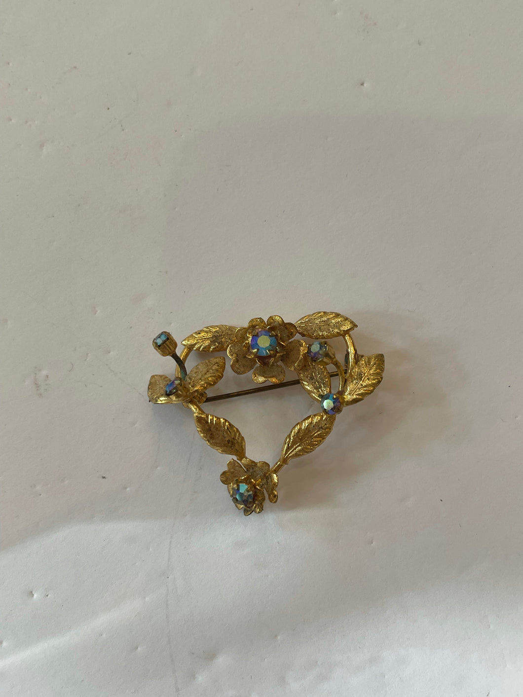 Gold floral heart brooch with iridescent jewels